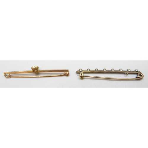 7009 - A 9ct gold bar brooch set with a tooth (2g) and another bar brooch
