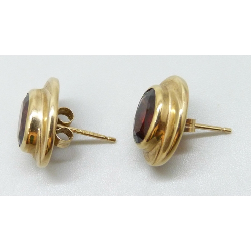7084 - A pair of 9ct yellow gold garnet set earrings, boxed, 4.1g