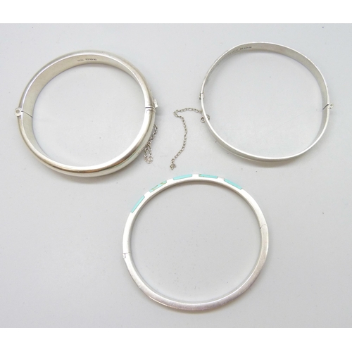 7109 - Three silver bangles, a silver McIntosh wristwatch and other Guess watch