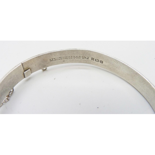 7109 - Three silver bangles, a silver McIntosh wristwatch and other Guess watch