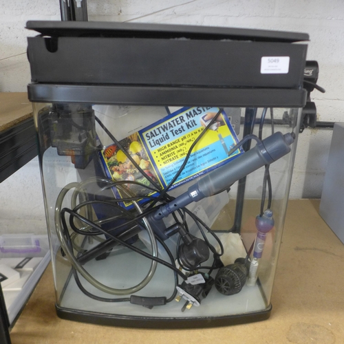 5049 - A glass aquarium tank with Hai-Yang tank light, a Saltwater Master liquid test kit, pumps, heaters a... 