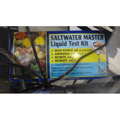5049 - A glass aquarium tank with Hai-Yang tank light, a Saltwater Master liquid test kit, pumps, heaters a... 