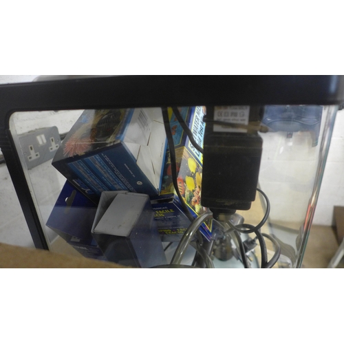 5049 - A glass aquarium tank with Hai-Yang tank light, a Saltwater Master liquid test kit, pumps, heaters a... 