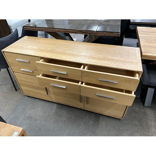3081 - An oak 6 drawer, 3 door sideboard