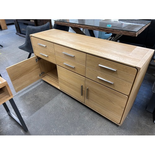 3081 - An oak 6 drawer, 3 door sideboard