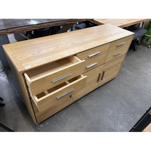 3081 - An oak 6 drawer, 3 door sideboard