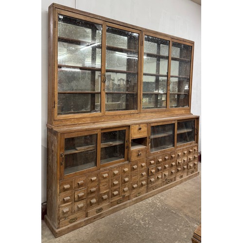 231 - A large early/mid 20th Century beech haberdashery shop cabinet