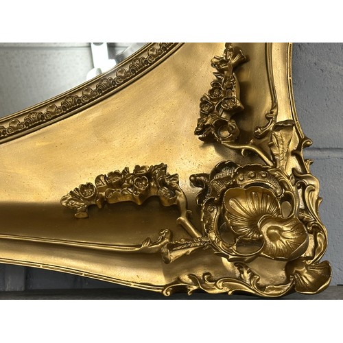 3187 - A gilt effect carved framed antique style mirror