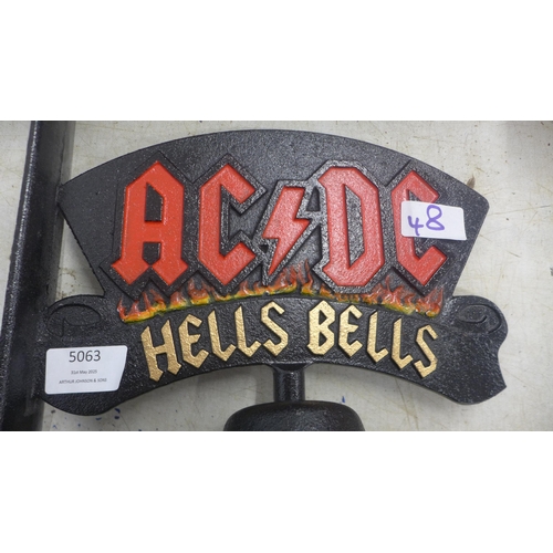 5063 - A cast metal AC/DC Hells bells wall mountable bell  *This lot is subject to VAT