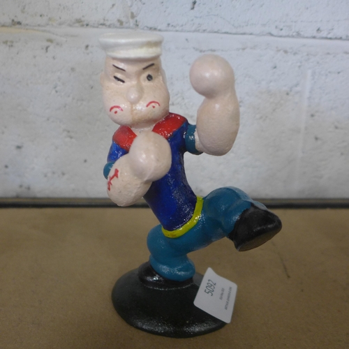 5092 - A cast metal Popeye figure and a cast metal  dog with a punching bag figure  *This lot is subject to... 