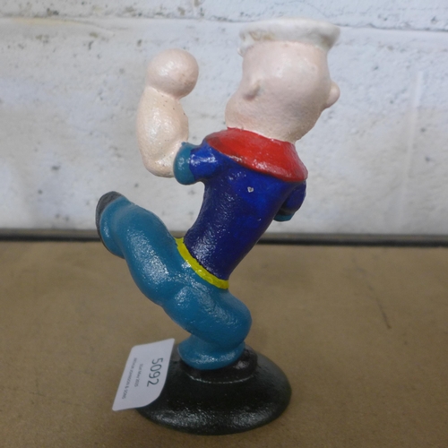 5092 - A cast metal Popeye figure and a cast metal  dog with a punching bag figure  *This lot is subject to... 