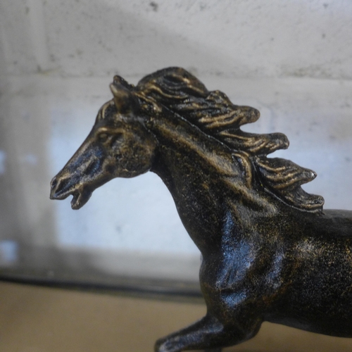 5093 - A cast metal running horse figure  *This lot is subject to VAT