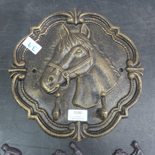 5100 - 2 cast metal coat racks  *This lot is subject to VAT