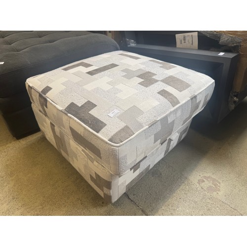 A white and grey patterned storage footstool (damaged)