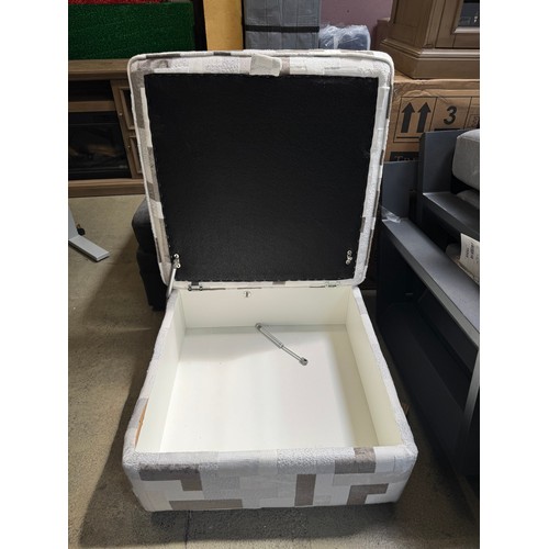 A white and grey patterned storage footstool (damaged)