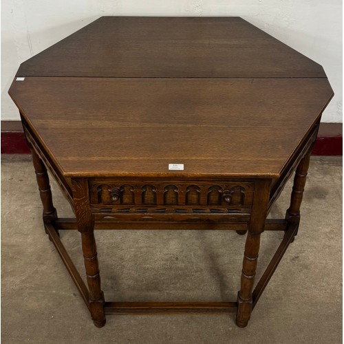 153 - A 17th Century style carved oak drop-leaf credence table