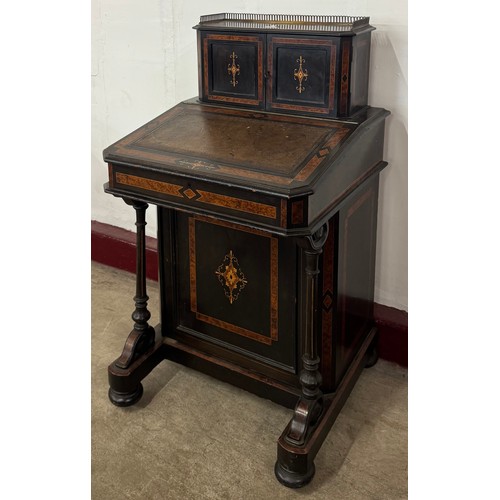 131 - A Victorian ebonised and amboyna Davenport