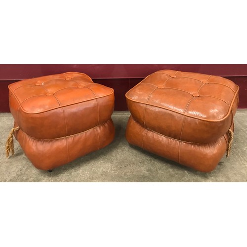 141A - A pair of tan leather pouffes