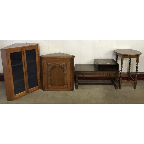 214 - An oak freestanding corner cupboard, a barleytwist occasional table and a telephone seat