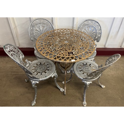 243 - A Victorian style cast alloy garden table and four chairs