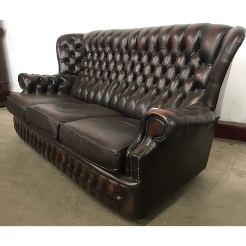 144B - A chestnut brown leather Chesterfield wingback settee and armchair