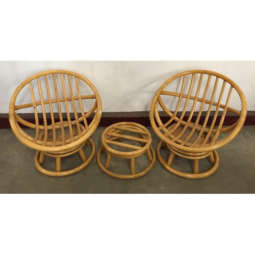 244B - A pair of Angraves Invincible bamboo revolving conservatory ball chairs and a footstool