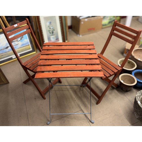 244 - A small wooden folding garden table and two chairs