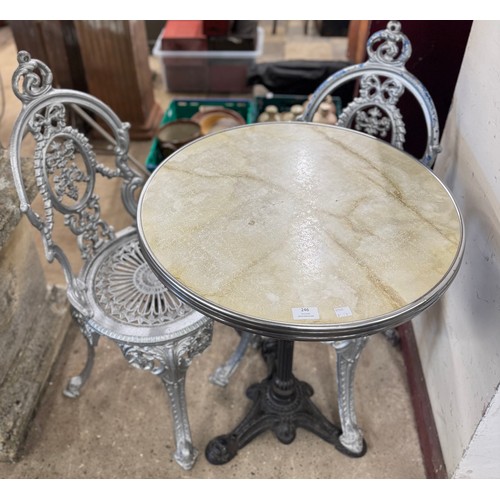 246 - A French style cast iron based garden table and two chairs