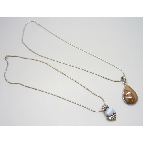 7027 - Two silver pendants and chains including an agate set example, 37g