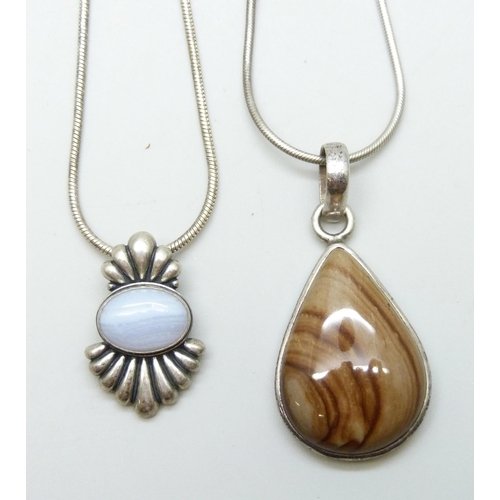 7027 - Two silver pendants and chains including an agate set example, 37g