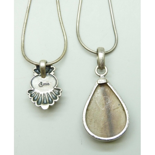 7027 - Two silver pendants and chains including an agate set example, 37g