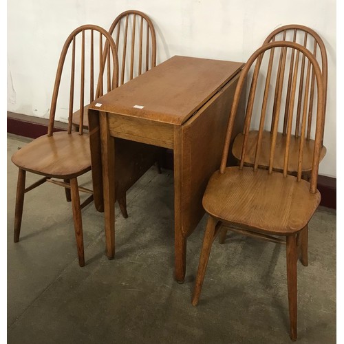 178 - A Priory oak drop-leaf dining table and four chairs