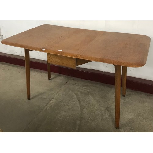 178 - A Priory oak drop-leaf dining table and four chairs