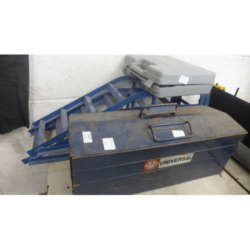 A pair of metal car ramps, a metal tool box containing spanners ...