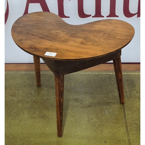 22 - A small teak boomerang shaped coffee table