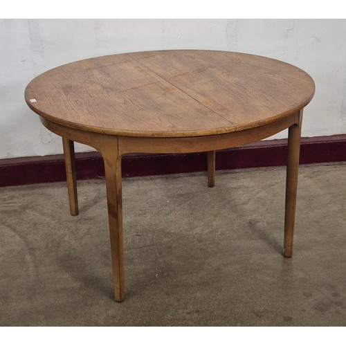 23 - A Nathan teak circular extending dining table