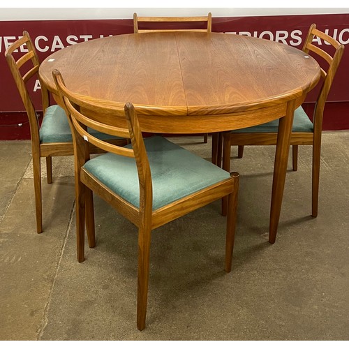 31 - A G-Plan Fresco teak circular extending dining table and four chairs
