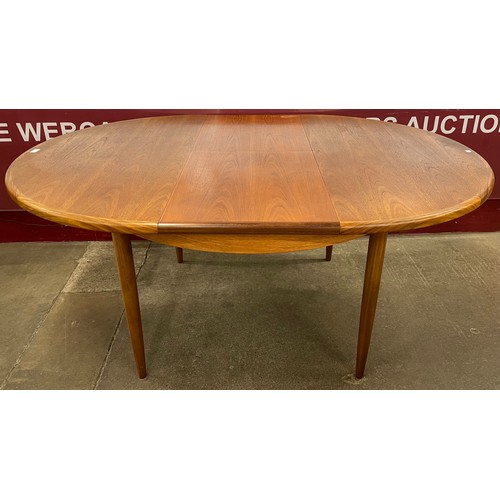 31 - A G-Plan Fresco teak circular extending dining table and four chairs