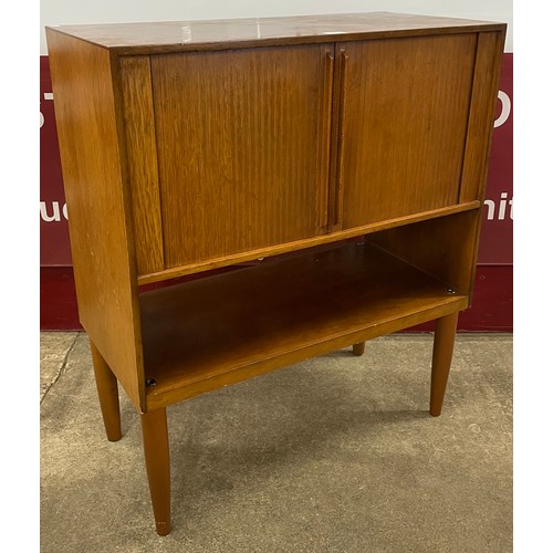 39 - A teak tambour front record cabinet