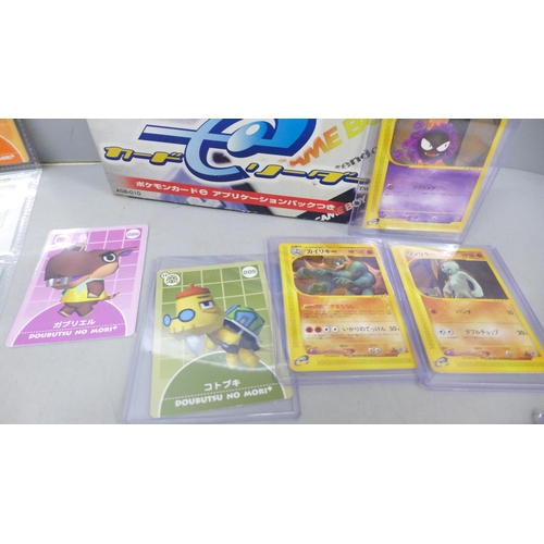 2052 - A Game Boy Advance card reader with readable Pokémon cards