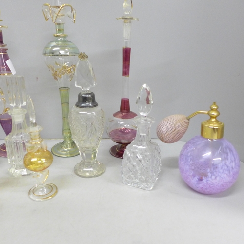 2058 - A large collection of decorative glass perfume bottles including Murano, Caithness, Bohemian glass a... 