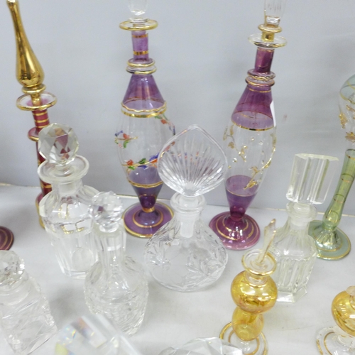 2058 - A large collection of decorative glass perfume bottles including Murano, Caithness, Bohemian glass a... 