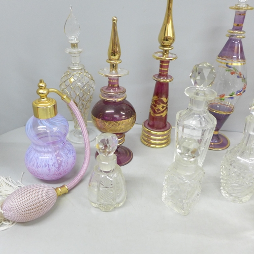2058 - A large collection of decorative glass perfume bottles including Murano, Caithness, Bohemian glass a... 