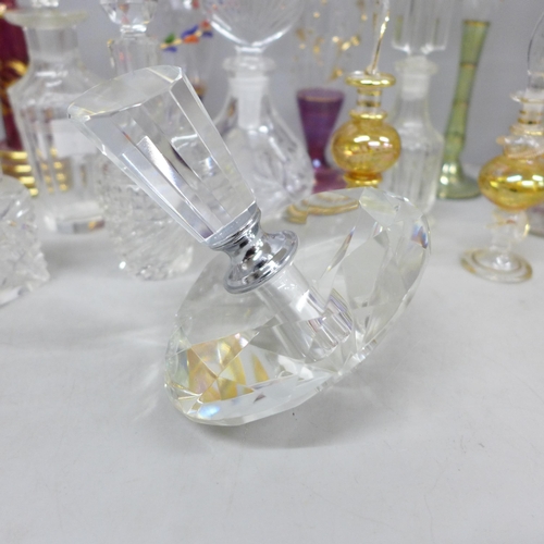 2058 - A large collection of decorative glass perfume bottles including Murano, Caithness, Bohemian glass a... 