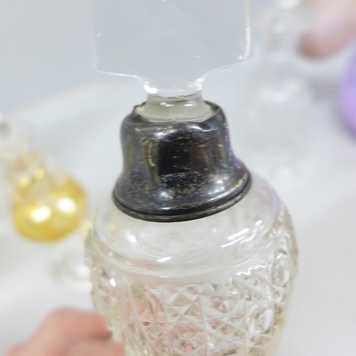 2058 - A large collection of decorative glass perfume bottles including Murano, Caithness, Bohemian glass a... 