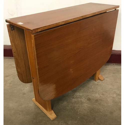 57 - A teak drop-leaf table