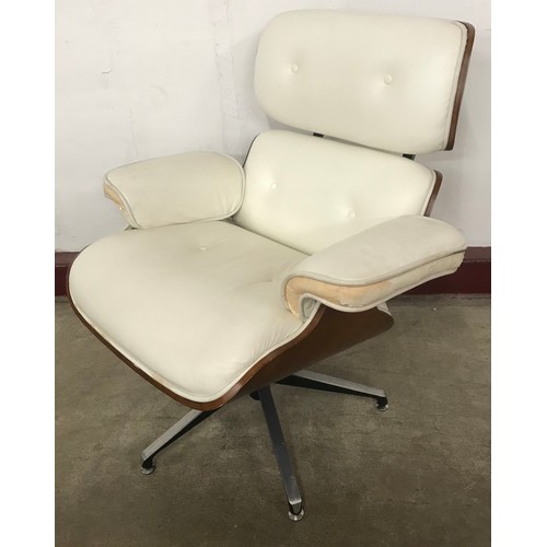 58 - A Charles & Ray Eames style simulated walnut, chrome and cream leather revolving lounge chair