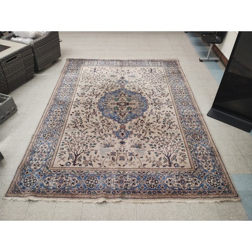 234 - A large Eastern blue ground rug, 370cm X 270cm
