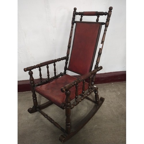 261 - A late 19th Century American oak and red leather rocking chair