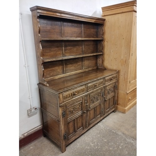 266A - A 17th Century style carved oak dresser